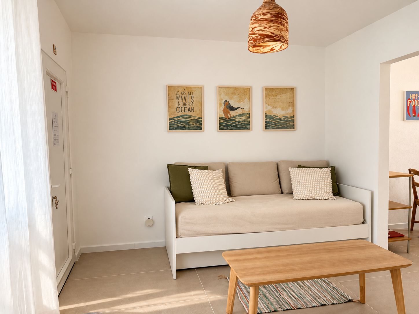 Daybed with a trio of ocean-themed prints above it
