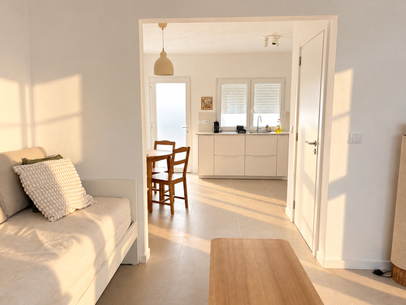 Bright living room with a daybed and ocean-themed prints